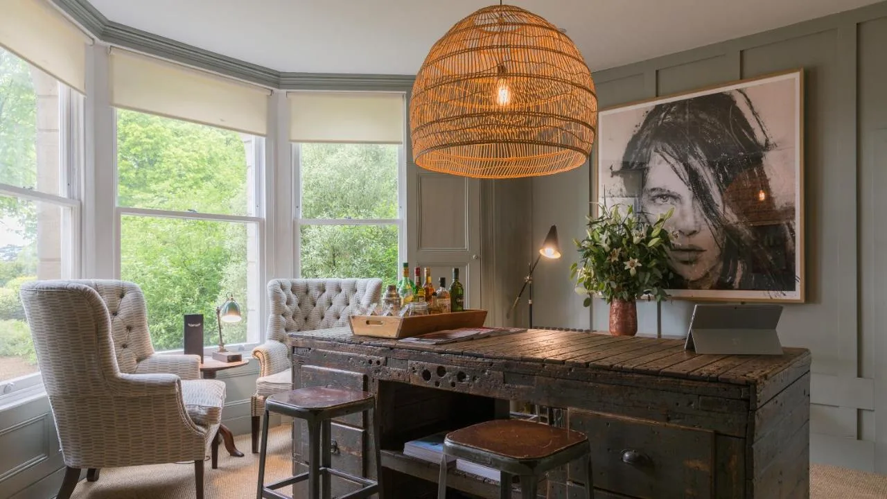 a living room with a wooden desk and a chandelier at Number 38 Clifton in Bristol