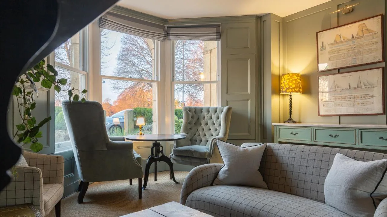 a living room with a couch and a table and a window at Number 38 Clifton in Bristol