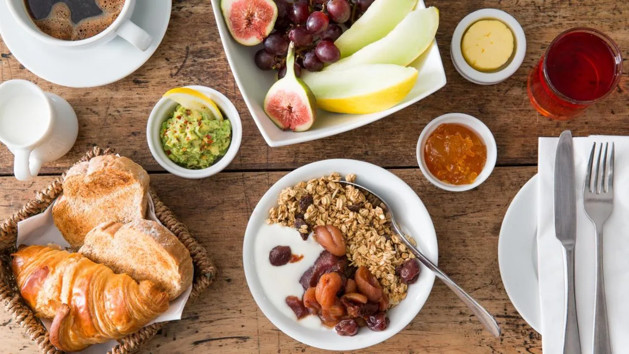 a table topped with plates of food with bread and fruit at Number 38 Clifton in Bristol